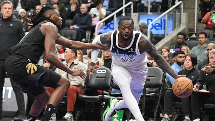 Nov 21, 2024; Toronto, Ontario, CAN;  Minnesota Timberwolves forward Julius Randle (30) dribbles the ball past Toronto Raptors forward Jonathan Mogbo (2) in the second half at Scotiabank Arena. Mandatory Credit: Dan Hamilton-Imagn Images