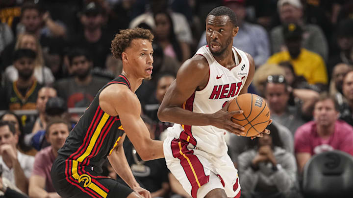 Apr 18, 2025; Atlanta, Georgia, USA; Miami Heat forward Andrew Wiggins (22) controls the ball against Atlanta Hawks guard Dyson Daniels (5) during the first half at State Farm Arena. Mandatory Credit: Dale Zanine-Imagn Images