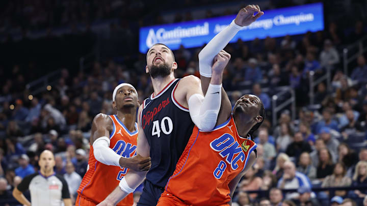 Nov 11, 2024; Oklahoma City, Oklahoma, USA; Los Angeles Clippers center Ivica Zubac (40) and Oklahoma City Thunder guard Shai Gilgeous-Alexander (2) and forward Jalen Williams (8) fight for a rebound during the fourth quarter at Paycom Center. Mandatory Credit: Alonzo Adams-Imagn Images