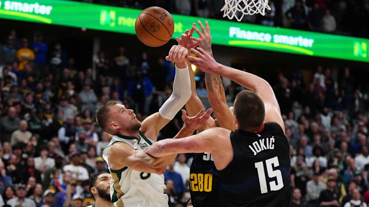Mar 7, 2024; Denver, Colorado, USA; Boston Celtics center Kristaps Porzingis (8) goes for a shot against the Denver Nuggets