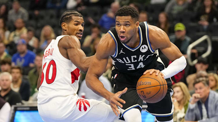 Nov 12, 2024; Milwaukee, Wisconsin, USA; Milwaukee Bucks forward Giannis Antetokounmpo (34) drives for the basket around Toronto Raptors guard Ochai Agbaji (30) during the fourth quarter at Fiserv Forum. Mandatory Credit: Jeff Hanisch-Imagn Images Nov 12, 2024; Milwaukee, Wisconsin, USA; Milwaukee Bucks forward Giannis Antetokounmpo (34) drives for the basket around Toronto Raptors guard Ochai Agbaji (30) during the fourth quarter at Fiserv Forum. Mandatory Credit: Jeff Hanisch-Imagn Images