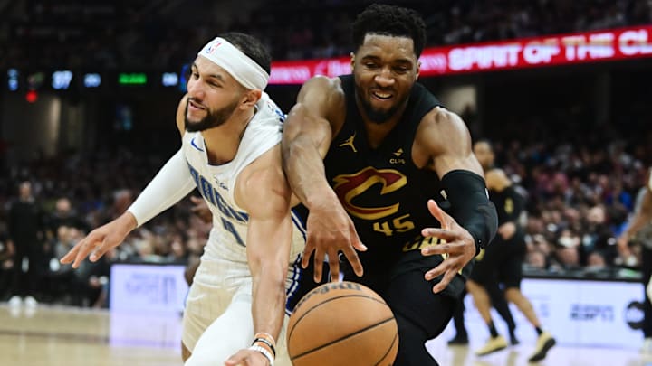 Cleveland Cavaliers guard Donovan Mitchell (45) goes for a loose ball against Orlando Magic guard Jalen Suggs (4) during the first half in game seven of the first round for the 2024 NBA playoffs at Rocket Mortgage FieldHouse.