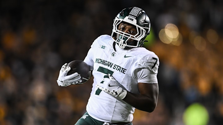 Nov 22, 2025; Iowa City, Iowa, USA; Michigan State Spartans running back Brandon Tullis (7) runs the ball against the Iowa Hawkeyes during the third quarter at Kinnick Stadium. Mandatory Credit: Jeffrey Becker-Imagn Images