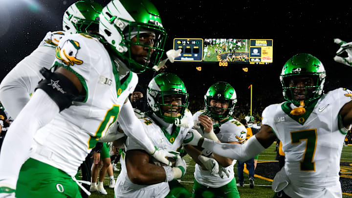 The Oregon Ducks celebrate after defeating the Iowa Hawkeyes Nov. 8, 2025 during a Big Ten Football game at Kinnick Stadium in Iowa City, Iowa.