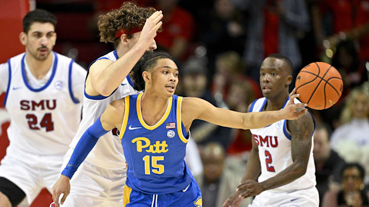 Feb 11, 2025; Dallas, Texas, USA; Pittsburgh Panthers guard Jaland Lowe (15) passes the ball by Southern Methodist Mustangs forward Matt Cross (33) during the second half at Moody Coliseum. Mandatory Credit: Jerome Miron-Imagn Images