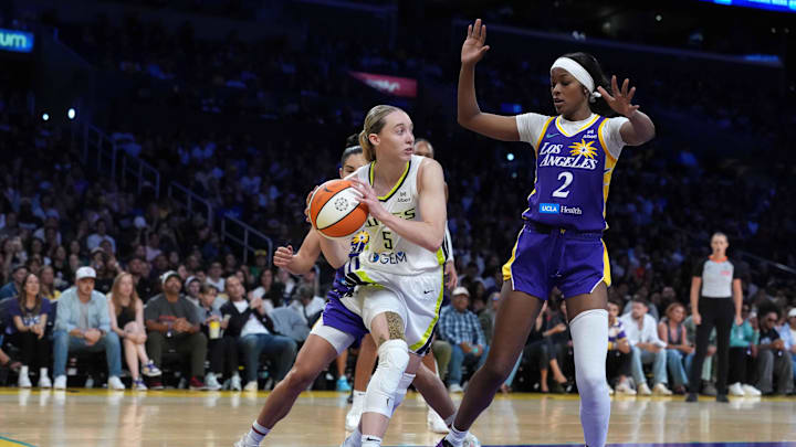 Aug 20, 2025; Los Angeles, California, USA; Dallas Wings guard Paige Bueckers (5) passes the ball against LA Sparks forward Rickea Jackson (2) and guard Kelsey Plum (10) in the second half at Crypto.com Arena. Mandatory Credit: Kirby Lee-Imagn Images Aug 20, 2025; Los Angeles, California, USA; Dallas Wings guard Paige Bueckers (5) passes the ball against LA Sparks forward Rickea Jackson (2) and guard Kelsey Plum (10) in the second half at Crypto.com Arena. Mandatory Credit: Kirby Lee-Imagn Images
