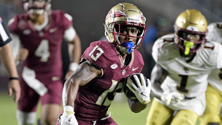 Sep 2, 2024; Tallahassee, Florida, USA; Florida State Seminoles running back Jaylin Lucas (13) runs the ball during the first half against the Boston College Eagles at Doak S. Campbell Stadium. Mandatory Credit: Melina Myers-Imagn Images