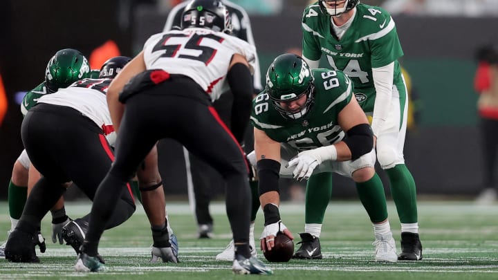 Dec 3, 2023; East Rutherford, NJ; New York Jets quarterback Trevor Siemian (14) lines up behind center Joe Tippmann (66) during the fourth quarter against the Atlanta Falcons at MetLife Stadium. 