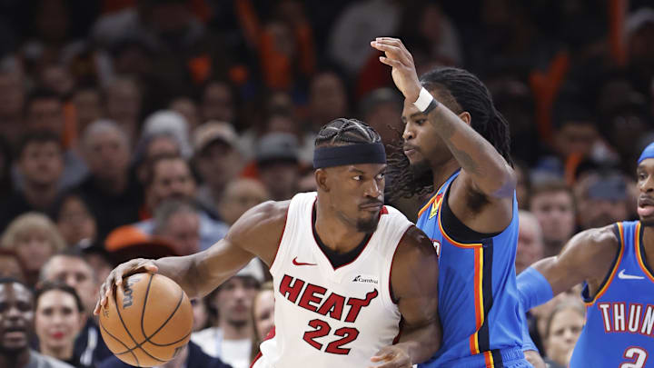 Mar 8, 2024; Oklahoma City, Oklahoma, USA; Miami Heat forward Jimmy Butler (22) drives against Oklahoma City Thunder guard Cason Wallace (22) during the second half at Paycom Center. Mandatory Credit: Alonzo Adams-Imagn Images