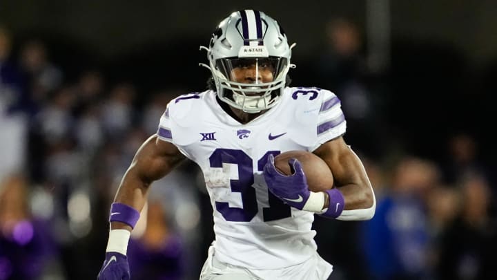 Nov 18, 2023; Lawrence, Kansas, USA; Kansas State Wildcats running back DJ Giddens (31) runs the ball during the first half against the Kansas Jayhawks at David Booth Kansas Memorial Stadium. Mandatory Credit: Jay Biggerstaff-USA TODAY Sports Nov 18, 2023; Lawrence, Kansas, USA; Kansas State Wildcats running back DJ Giddens (31) runs the ball during the first half against the Kansas Jayhawks at David Booth Kansas Memorial Stadium. Mandatory Credit: Jay Biggerstaff-USA TODAY Sports