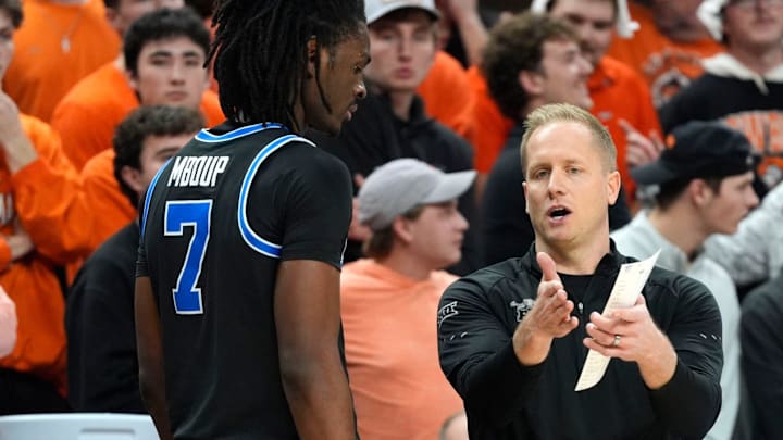 BYU coach Kevin Young talks with BYU Cougars forward Khadim Mboup (7) during a BIG 12 men's college basketball game between the Oklahoma State Cowboys (OSU) and the BYU Cougars at Gallagher-Iba Arena in Stillwater, Okla., Wednesday, Feb. 4, 2026.