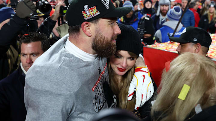 Recording artist Taylor Swift  and Kansas City Chiefs tight end Travis Kelce (87) react after the AFC Championship game against the Buffalo Bills at GEHA Field at Arrowhead Stadium.