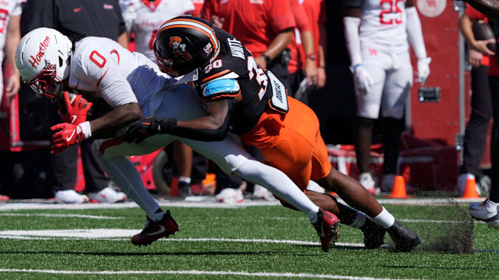 Oklahoma State Cowboys linebacker Trip White (30) brings down Houston Cougars wide receiver Amare Thomas (0) during a college football game between the Oklahoma State Cowboys (OSU) and the Houston Cougars at Boone Pickens Stadium in Stillwater, Okla., Saturday, Oct. 11, 2025. Houston won 39-17. Oklahoma State Cowboys linebacker Trip White (30) brings down Houston Cougars wide receiver Amare Thomas (0) during a college football game between the Oklahoma State Cowboys (OSU) and the Houston Cougars at Boone Pickens Stadium in Stillwater, Okla., Saturday, Oct. 11, 2025. Houston won 39-17.