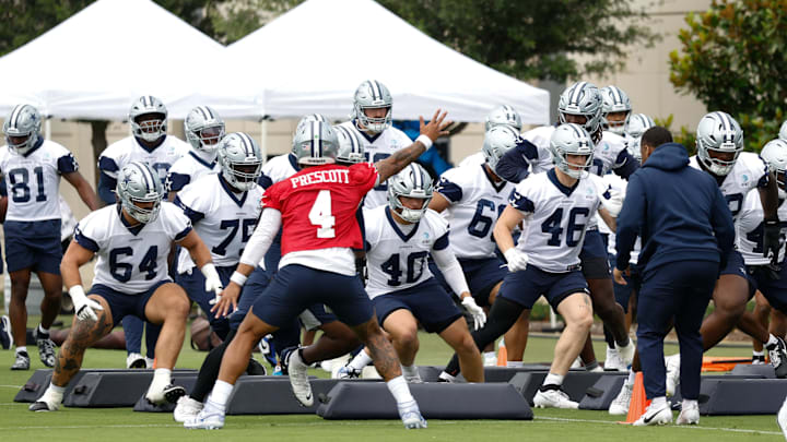 Dallas Cowboys quarterback Dak Prescott leads teammates through a drill at the Ford Center at the Star Training Facility.