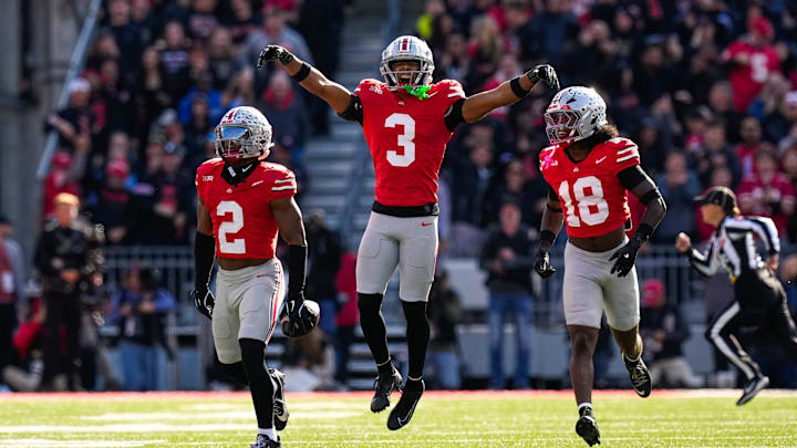 Ohio State Buckeyes defensive back Caleb Downs (2) celebrates with safety Jaylen McClain (18) and linebacker Sonny Styles (0) after Downs intercepted a pass in the second half at Ohio Stadium on Saturday, Nov. 1, 2025 in Columbus, Ohio.
