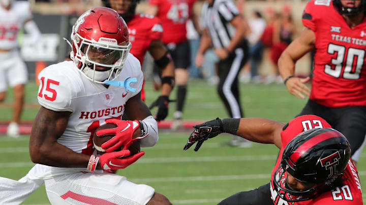 Sep 30, 2023; Lubbock, Texas, USA; Houston Cougars punt returner Malik Fleming (15) brings the ball back against Texas Tech Red Raiders special teams player Nehemiah Martinez I (20) in the second half at Jones AT&T Stadium and Cody Campbell Field. Mandatory Credit: Michael C. Johnson-Imagn Images Sep 30, 2023; Lubbock, Texas, USA; Houston Cougars punt returner Malik Fleming (15) brings the ball back against Texas Tech Red Raiders special teams player Nehemiah Martinez I (20) in the second half at Jones AT&T Stadium and Cody Campbell Field. Mandatory Credit: Michael C. Johnson-Imagn Images