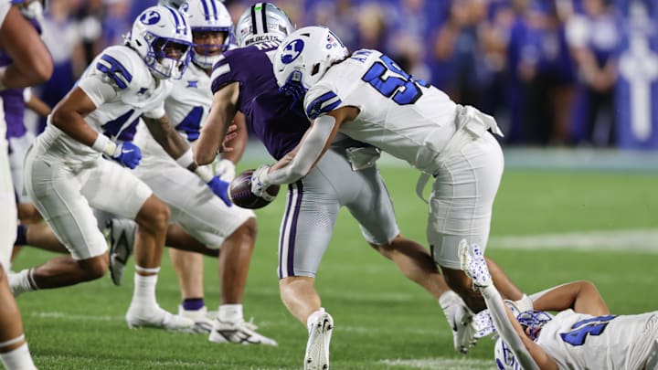 Sep 21, 2024; Provo, Utah, USA; Brigham Young Cougars linebacker Aisea Moa (58) forces a fumble by Kansas State Wildcats quarterback Jacob Knuth (7) during the fourth quarter at LaVell Edwards Stadium. Mandatory Credit: Rob Gray-Imagn Images