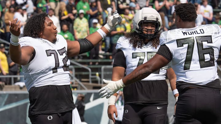 Oregon’s Iapani Laloulu, left, Lipe Moala and Isaiah World dance to the song “Shout” during the Oregon Spring Game at Autzen in Eugene April 26, 2025.