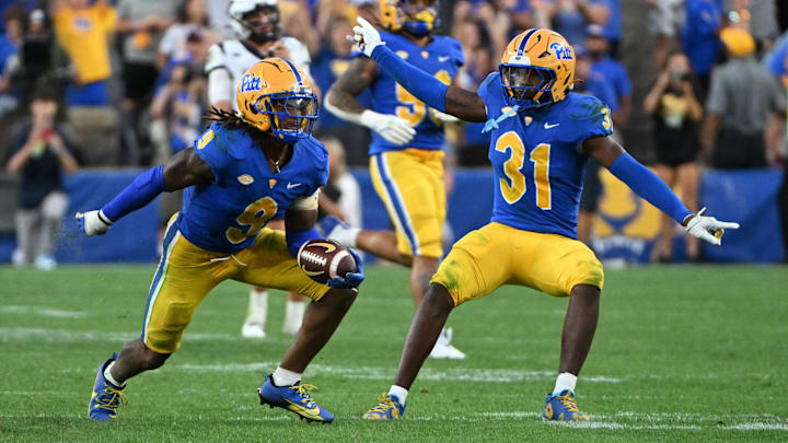 Sep 14, 2024; Pittsburgh, Pennsylvania, USA; Pittsburgh Panthers linebacker Kyle Louis celebrates with linebacker Rasheem Biles (31) after intercepting West Virginia Mountaineers quarterback Garrett Greene (6) in the fourth quarter at Acrisure Stadium. Mandatory Credit: Barry Reeger-Image Images