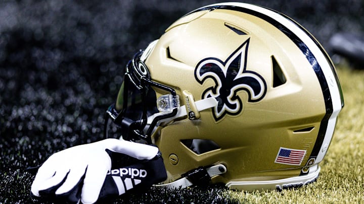 Aug 13, 2023; New Orleans, Louisiana, USA; Detailed view of the New Orleans Saints helmet and glove during pregame against the Kansas City Chiefs at the Caesars Superdome. Mandatory Credit: Stephen Lew-Imagn Images Aug 13, 2023; New Orleans, Louisiana, USA; Detailed view of the New Orleans Saints helmet and glove during pregame against the Kansas City Chiefs at the Caesars Superdome. Mandatory Credit: Stephen Lew-Imagn Images
