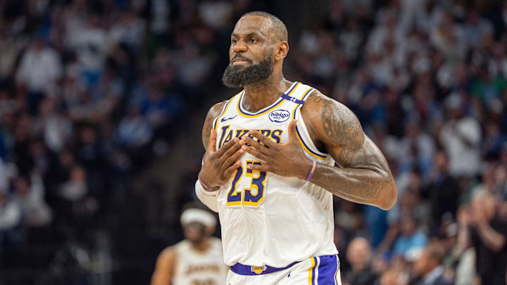 Los Angeles Lakers forward LeBron James (23) talks with his coach during a stoppage in play against the Minnesota Timberwolves in the second quarter during game four of first round for the 2025 NBA Playoffs at Target Center.