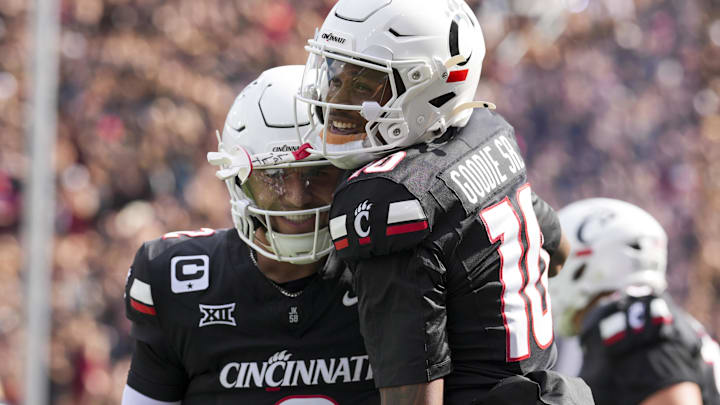 Sep 13, 2025; Cincinnati, Ohio, USA; Cincinnati Bearcats wide receiver Caleb Goodie (10) celebrates with quarterback Brendan Sorsby (2) after scoring a touchdown against the Northwestern State Demons in the first half at Nippert Stadium. Mandatory Credit: Aaron Doster-Imagn Images Sep 13, 2025; Cincinnati, Ohio, USA; Cincinnati Bearcats wide receiver Caleb Goodie (10) celebrates with quarterback Brendan Sorsby (2) after scoring a touchdown against the Northwestern State Demons in the first half at Nippert Stadium. Mandatory Credit: Aaron Doster-Imagn Images