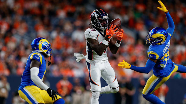 Aug 26, 2023; Denver, Colorado, USA; Denver Broncos wide receiver Brandon Johnson (89) makes a catch against Los Angeles Rams safety Quindell Johnson (39) and cornerback Robert Rochell (8) in the second quarter at Empower Field at Mile High. Mandatory Credit: Isaiah J. Downing-Imagn Images