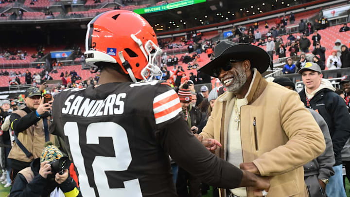 Dec 28, 2025; Cleveland, Ohio, USA; Cleveland Browns quarterback Shedeur Sanders (12) and his father Deion Sanders on the sideline before the game against the Pittsburgh Steelers at Huntington Bank Field. Mandatory Credit: Ken Blaze-Imagn Images