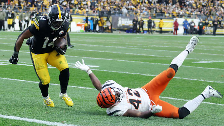 Nov 16, 2025; Pittsburgh, Pennsylvania, USA; Pittsburgh Steelers running back Kenneth Gainwell (14) runs with the ball against Cincinnati Bengals linebacker Oren Burks (42) during the second half at Acrisure Stadium. Mandatory Credit: Charles LeClaire-Imagn Images