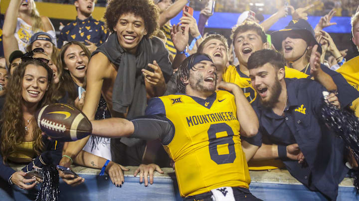 Sep 16, 2023; Morgantown, West Virginia, USA; West Virginia Mountaineers quarterback Nicco Marchiol (8) celebrates with fans after defeating the Pittsburgh Panthers at Mountaineer Field at Milan Puskar Stadium. Mandatory Credit: Ben Queen-Imagn Images