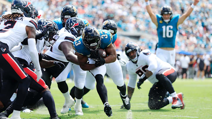 Jacksonville Jaguars running back Bhayshul Tuten (33) scores a rushing touchdown as quarterback Trevor Lawrence (16) celebrates during the first quarter of an NFL football matchup at EverBank Stadium, Sunday, Sept. 21, 2025, in Jacksonville, Fla. The Jaguars defeated the Texans 17-10. The Jaguars defeated the Texans 17-10.