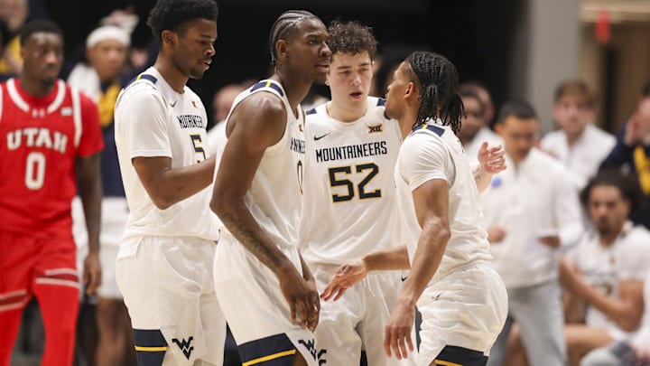 Feb 18, 2026; Morgantown, West Virginia, USA; West Virginia Mountaineers players celebrate after a defensive play during the first half against the Utah Utes at Hope Coliseum. Mandatory Credit: Ben Queen-Imagn Images