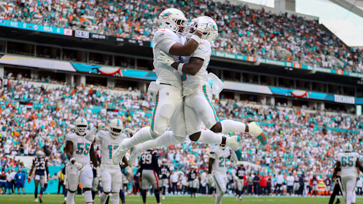 Miami Dolphins tight end Jonnu Smith (9) celebrates with wide receiver Tyreek Hill (10) after scoring a touchdown against the New England Patriots during the first quarter at Hard Rock Stadium. 