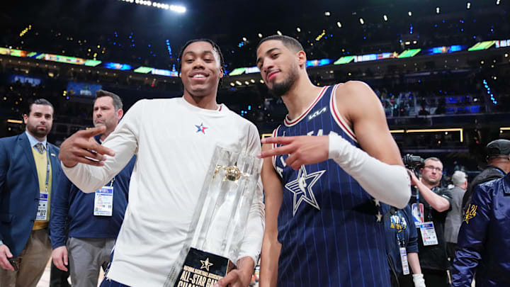 Scottie Barnes and Tyrese Haliburton celebrate with the All-Star game trophy.