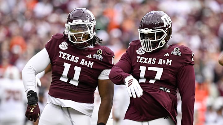 Dec 20, 2025; College Station, TX, USA; Texas A&M Aggies defensive tackle Albert Regis (17) and defensive tackle Tyler Onyedim (11) celebrate during the game between the Aggies and the Hurricanes at Kyle Field. Mandatory Credit: Jerome Miron-Imagn Images