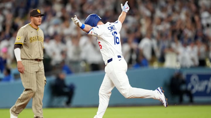 Jun 18, 2025; Los Angeles, California, USA; Los Angeles Dodgers catcher Will Smith (16) runs the bases after hitting a walkoff home run as San Diego Padres third baseman Manny Machado (13) watches at Dodger Stadium. Mandatory Credit: Kirby Lee-Imagn Images