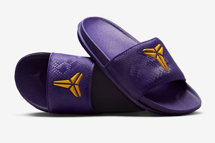 purple nike slides with gold check