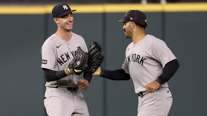 Sep 4, 2025; Houston, Texas, USA; New York Yankees center fielder Trent Grisham (12) celebrates right fielder Cody Bellinger (35) catch against Houston Astros catcher Yainer Diaz (21)(not pictured) to end the sixth inning at Daikin Park. Mandatory Credit: Thomas Shea-Imagn Images