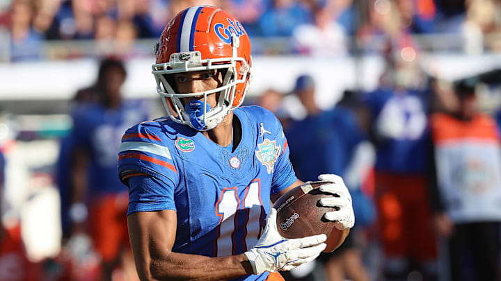 Dec 20, 2024; Tampa, FL, USA; Florida Gators wide receiver Aidan Mizell (11) runs with the ball against the Tulane Green Wave during the first quarter at Raymond James Stadium. Mandatory Credit: Kim Klement Neitzel-Imagn Images