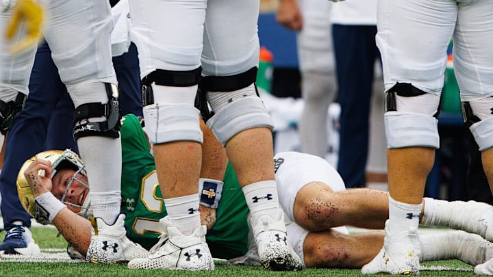 Notre Dame quarterback Riley Leonard (13) lays on the ground after being tackled during a NCAA college football game between Notre Dame and Louisville at Notre Dame Stadium on Saturday, Sept. 28, 2024, in South Bend. Notre Dame quarterback Riley Leonard (13) lays on the ground after being tackled during a NCAA college football game between Notre Dame and Louisville at Notre Dame Stadium on Saturday, Sept. 28, 2024, in South Bend.