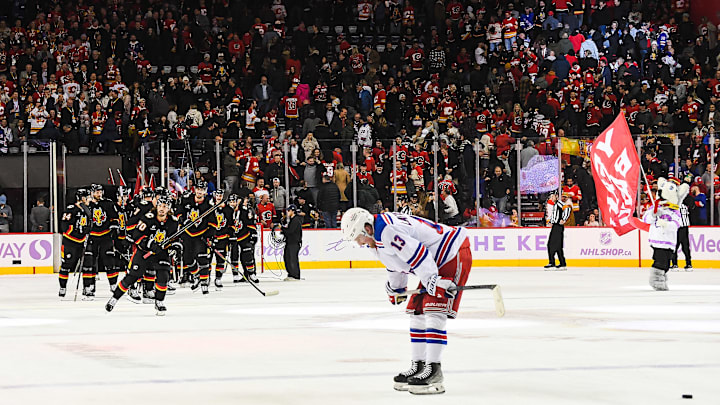 The Flames celebrate as Alexis Lafreniere skates off