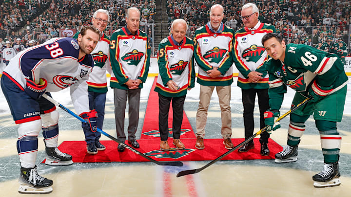 Blue Jackets captain Boone Jenner and Wild captain Jared Spurgeon line up for a ceremonial puck drop in front of some Minnesota hockey greats. Blue Jackets captain Boone Jenner and Wild captain Jared Spurgeon line up for a ceremonial puck drop in front of some Minnesota hockey greats.
