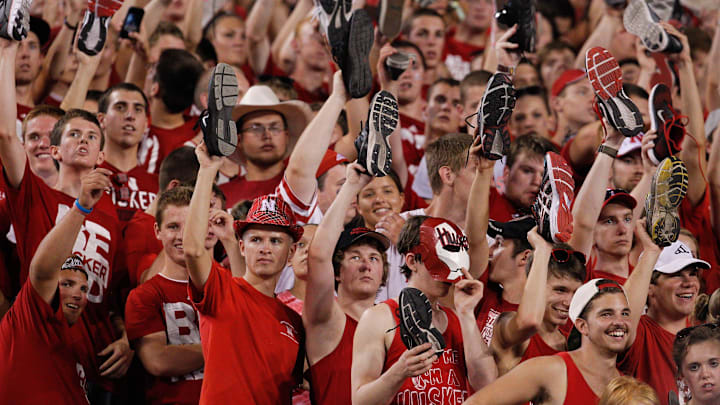 Aug 31, 2013; Lincoln, NE, USA; Nebraska Cornhuskers fans hold up  shoes prior to the second-half kickoff against the Wyoming Cowboys at Memorial Stadium.