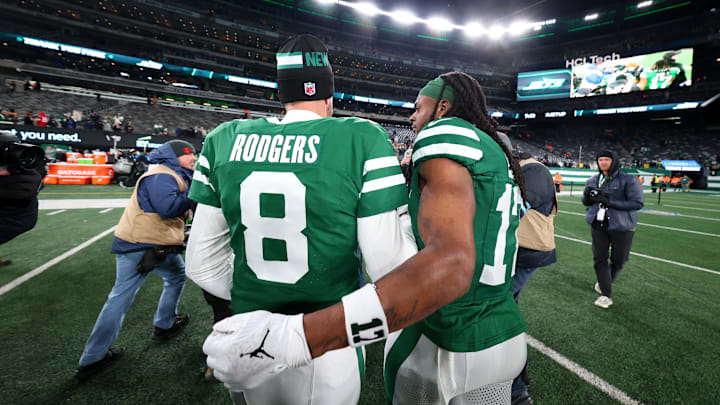 Jan 5, 2025; East Rutherford, New Jersey, USA; New York Jets quarterback Aaron Rodgers (8) and wide receiver Davante Adams (17) walk on the field after the Jets win over the Miami Dolphins at MetLife Stadium. Mandatory Credit: Ed Mulholland-Imagn Images
