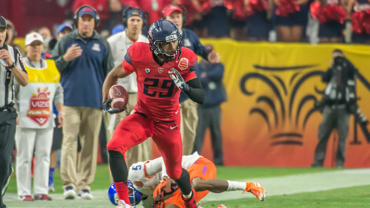 Austin Hill running down the sideline after catching a pass. 