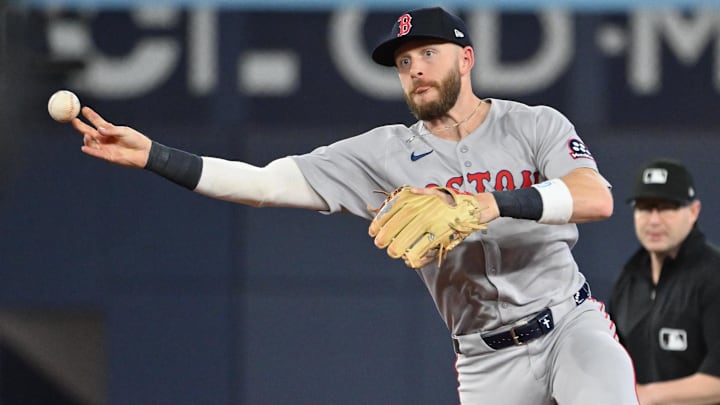 May 1, 2025; Toronto, Ontario, CAN;  Boston Red Sox shortstop Trevor Story (10) throws out Toronto Blue Jays catcher Alejandro Kirk (not shown) in the seventh inning at Rogers Centre. Mandatory Credit: Dan Hamilton-Imagn Images