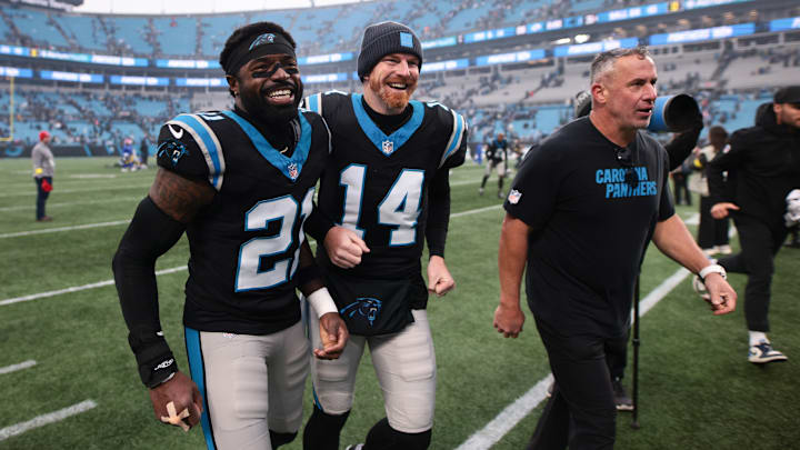 Nov 30, 2025; Charlotte, North Carolina, USA; Carolina Panthers safety Nick Scott (21) and Carolina Panthers quarterback Andy Dalton (14) celebrate after the game against the Los Angeles Rams at Bank of America Stadium.