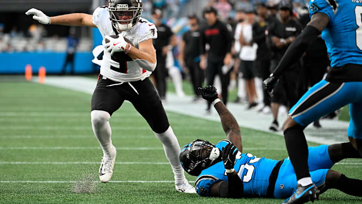 Oct 13, 2024; Charlotte, North Carolina, USA; Atlanta Falcons wide receiver Drake London (5) with the ball as Carolina Panthers linebacker Claudin Cherelus (53) and cornerback Jaycee Horn (8) defend in the second quarter at Bank of America Stadium.