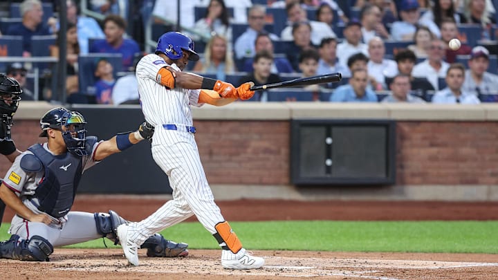 Aug 12, 2025; New York City, New York, USA;  New York Mets center fielder Cedric Mullins (28) hits an RBI single in the second inning against the Atlanta Braves at Citi Field. Mandatory Credit: Wendell Cruz-Imagn Images
