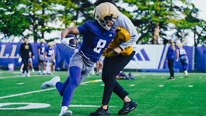 Chris Lawson wheels around a coach on the East practice field. 